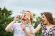 © Voyagerix - Couple blowing soap bubbles, having fun