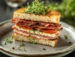 © Bijac - artisanal club sandwich on rustic sourdough, layers of house-cured bacon, heirloom tomatoes, and microgreens, styled on vintage ceramic plate with fresh herbs