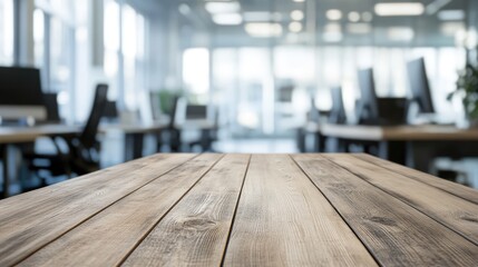 Poster - Empty wooden table surface with a blurred modern office background featuring desks and computer screens. Ideal for showcasing products or workplace presentations