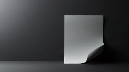 Poster - White sheet of paper curling up from a dark gray floor against a dark wall