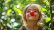 © Phlegmatic Tigress - Smiling girl with clown nose outdoors in sunlight, April fools day, Clown Nose