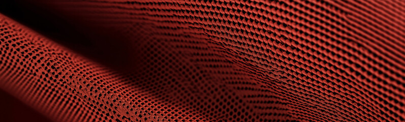 Red wavy mesh fabric forming an abstract pattern