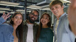 © Yuliia - Happy multiracial friends group multinational diversity people women men students girls guys business colleagues friendship posing together in office smiling laughing for selfie photo on mobile phone