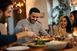 © Macrostock - Happy Middle Eastern family enjoys in Ramadan dinner at dining table.