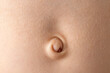 © SOLDATOOFF - Close-up of a baby navel with delicate skin in soft lighting, highlighting the texture.