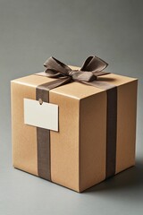 Poster - Square cardboard gift box wrapped with brown paper and ribbon with blank gift tag