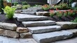 © atipong - Natural stone landscaping in home garden with steps and flowerbeds