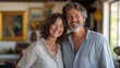 © Mechastock - Mature couple smiles joyfully, capturing their deep connection while surrounded by personal items that reflect their shared history