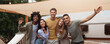 © Prostock-studio - Group of millennial diverse friends posing and smiling at camera near RV, enjoying fun weekend together on camping trip. Happy fellow students traveling together in motorhome, full length portrait