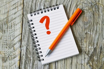 Poster - Red question mark notepad and an orange pen resting on a weathered wooden table