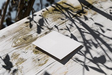 Poster - Mockup of white square card on wooden table with plant shadows