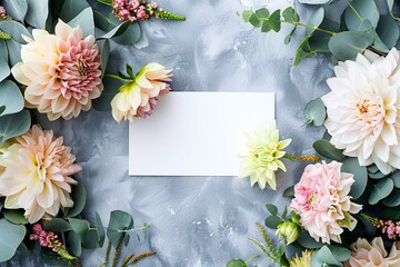 Wall Mural - Gray background with eucalyptus branches and pink and white dahlia flowers surrounding a blank card