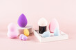 © ADDICTIVE STOCK - Assorted makeup sponges displayed on a pink background