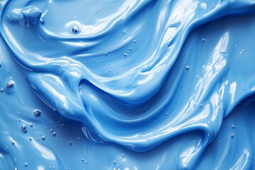 Aufkleber - Swirling blue paint creates a mesmerizing texture with glossy surfaces and soft waves under bright light