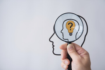 Poster - Illuminating Insights: Unveiling Solutions Through Creative Inquiry. A hand holds a magnifying glass over question marks, illuminating a light bulb –           