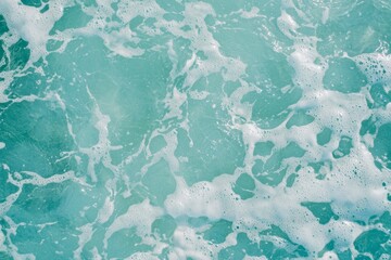Poster - Gentle waves creating white foam and bubbles on the surface of turquoise sea water, forming a beautiful natural pattern, ideal for backgrounds and summer-themed designs