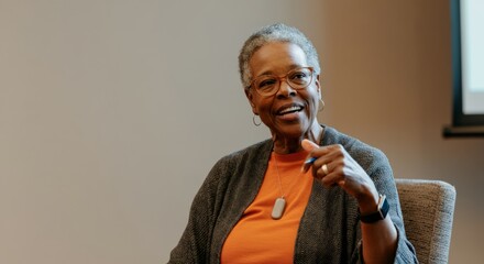 Wall Mural - Woman in glasses and an orange shirt pointing