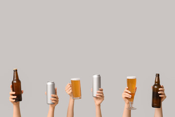 Wall Mural - Female hands with fresh beer in bottles, cans, mug and glass on white background