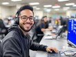 © Tondone - A cheerful young man working in a modern office setting, wearing a headset and smiling at the camera