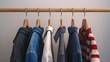 © HISTOCK - Varieties of men's casual attire displayed on wooden hangers on a clothes rack