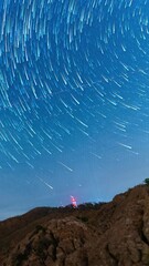 Wall Mural - vertical time lapse of spinning night sky