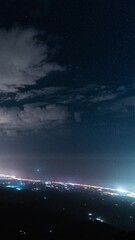 Wall Mural - glowing coastline of spain at night with starry sky above, time lapse