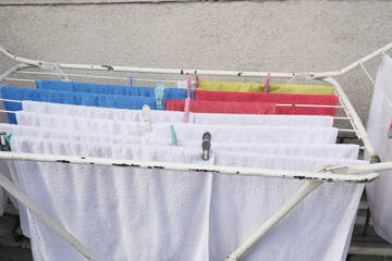 Colorful towels drying on a clothesline in the sunlight