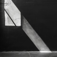 Wall Mural - light and shadow cast on a dark wall from a window.