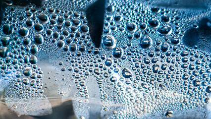 Wall Mural - Water droplets on the surface of a plastic bottle. Close-up.