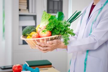 Wall Mural - A male nutritionist sitting at a table, advising on healthy diets, promoting vegetable-based meals, supplements, weight loss, and meal planning to improve overall health and well-being