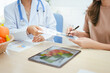 © NanSan - A young female nutritionist expert talks to a female patient at a table, recommending a healthy diet with vegetables and fruits to promote wellness, balanced nutrition, and effective weight loss