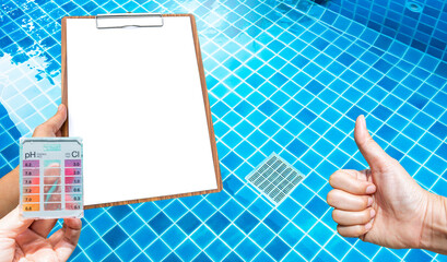 Wall Mural - Water tester in girl hand and blank report paper on wooden clipboard with thumbs up hand over clear swimming pool water background, good quality water, water tester test kit