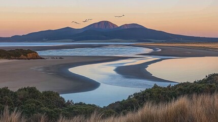 Sticker - Serene coastal landscape at sunrise with winding river, tranquil beach, and mountains in the background.