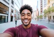 © buakhiao - Joyful young man smiling widely in urban street setting with beautiful city backdrop during daytime