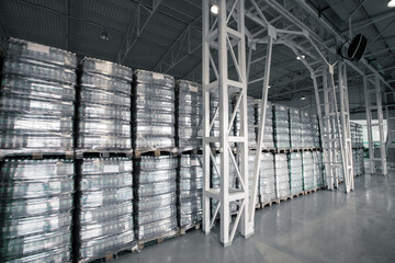 Poster - stacks of pallets filled with goods organized in a spacious warehouse in bright light during daytime