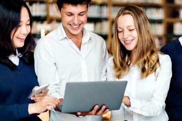 Poster - Diverse students using laptop in library