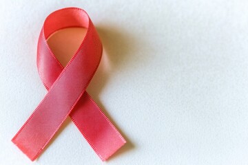 Poster - A pink ribbon on a white surface