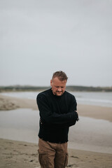 Wall Mural - Contemplative Man Walking on a Beach