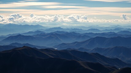 majestic panoramic view of endless blue mountain ranges under a partly cloudy sky, showcasing layers