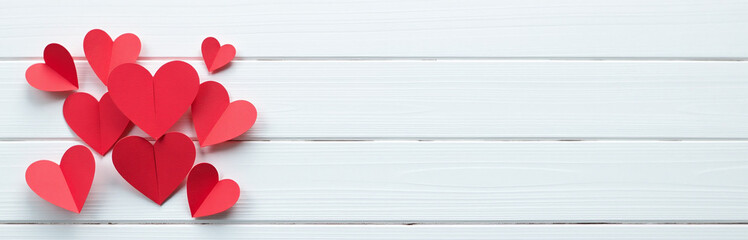 Poster - A Minimalist Design Features Small Red Paper Hearts Against A White Wooden Background, Ideal For A Postcard Or Love Message. 00001