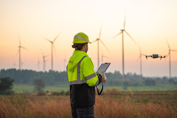 Wall Mural - engineer specialists pilot drone on wind turbine farm. architectural engineer and safety engineering