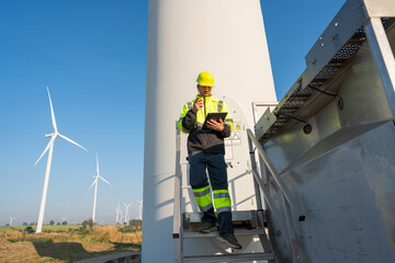 Wall Mural - engineer wearing uniform inspection and survey work in wind turbine farms rotation to generate elect