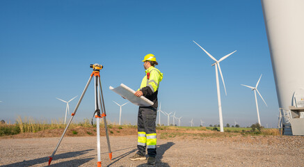 Wall Mural - engineer wearing uniform inspection and survey work in wind turbine farms rotation to generate elect
