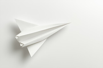 Poster - A simple paper airplane drifts softly in midday light on a neutral white background, representing freedom, creativity, and the spirit of exploration in minimalist design