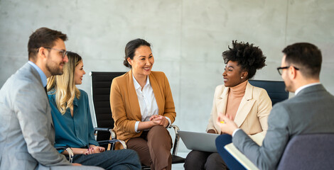 Wall Mural - Multicultural professional businesspeople working together on research plan in boardroom.