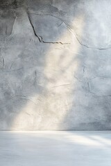 Poster - Rough concrete wall illuminated by soft light showcases texture and shadow interplay in a minimalist interior, creating a serene ambiance perfect for artistic expression