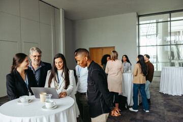 Wall Mural - business professionals engaging in lively discussions during a conference tea break