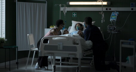 Wall Mural - Young father and mother visit their daughter who is in intensive care.