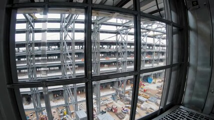 Aufkleber - Construction elevator showcased at a busy building site in afternoon light