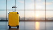 Close-up of suitcases in an airport lounge, with natural light illuminating the scene, capturing a moment of travel preparation and anticipation. 